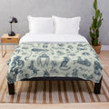 Plush blanket featuring a pattern of fantasy creatures and mythical beings