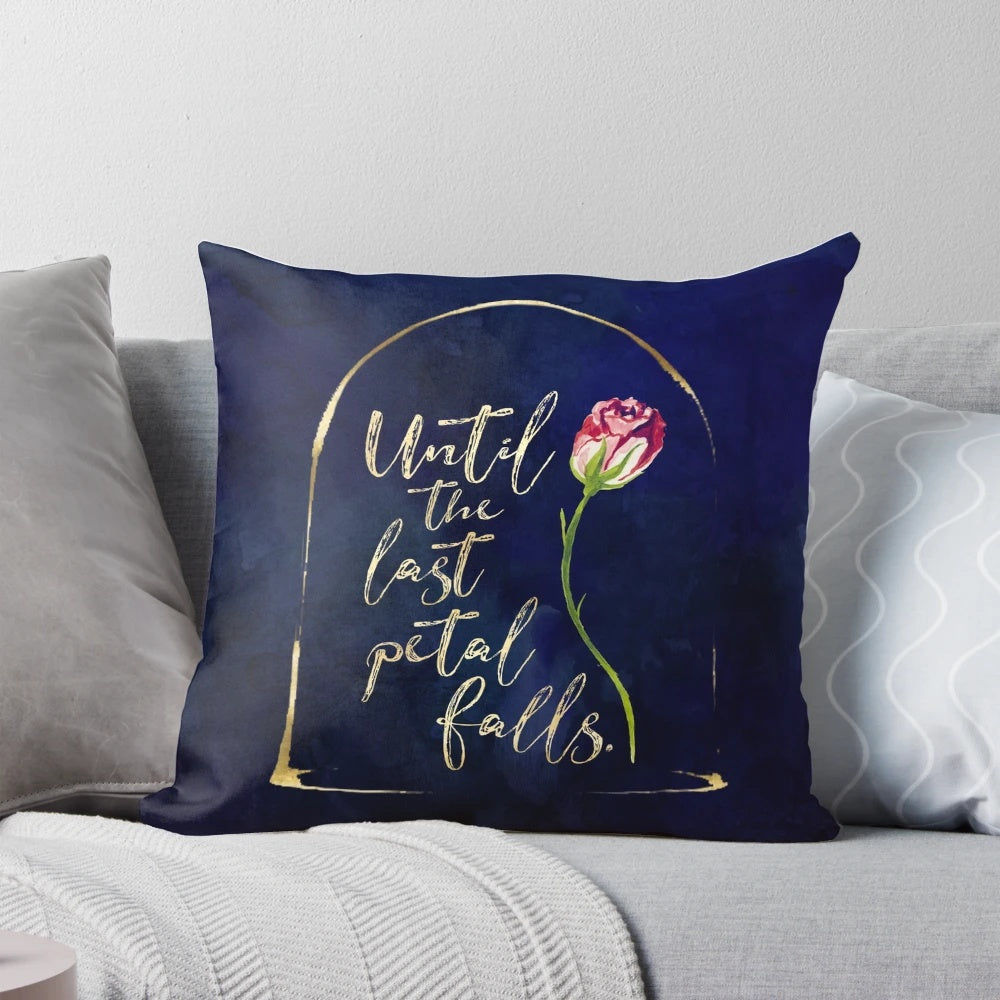 Decorative throw pillow featuring an enchanted rose illustration and quote from the Beauty and the Beast fairy tale.