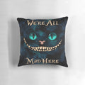 Whimsical Alice in Wonderland-themed pillow with illustrations of the Cheshire Cat, Mad Hatter, and other iconic characters.