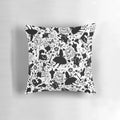 Colorful Alice in Wonderland inspired decorative pillow with pattern of characters, flowers, and symbols