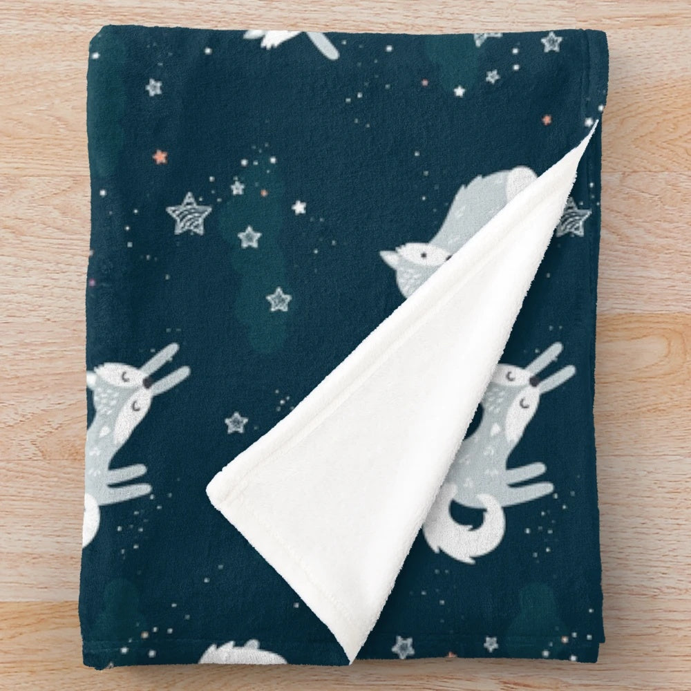Plush blanket featuring adorable arctic foxes under a starry night sky
