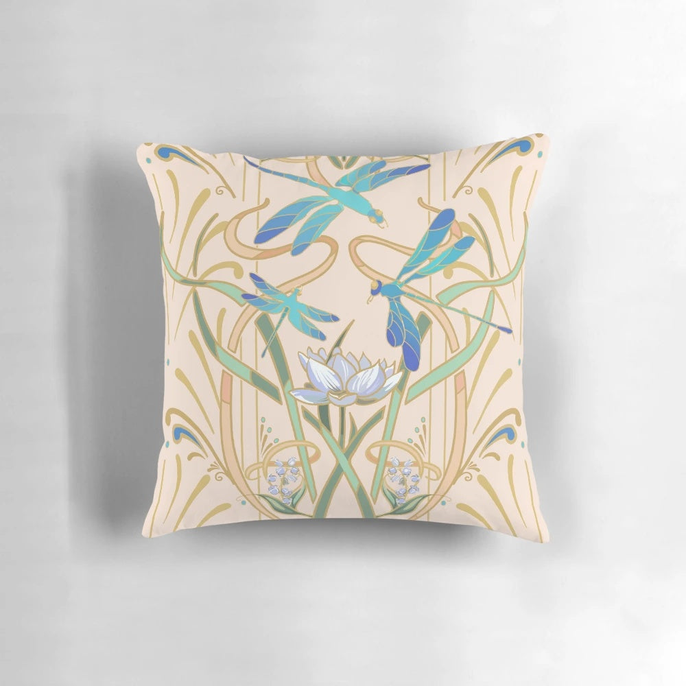 Blush-colored art nouveau style pillow with a repeating dragonfly pattern
