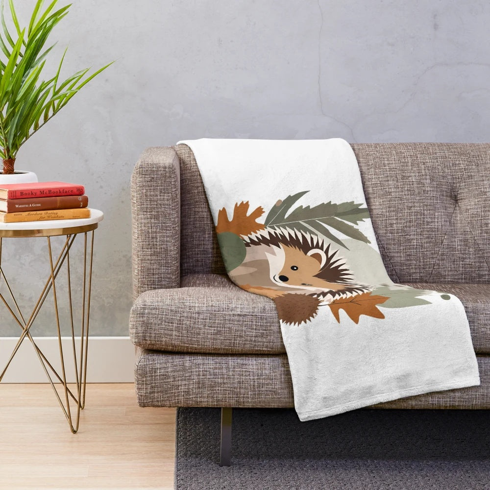 Soft plush blanket featuring a delightful hedgehog design against an autumn leaf background