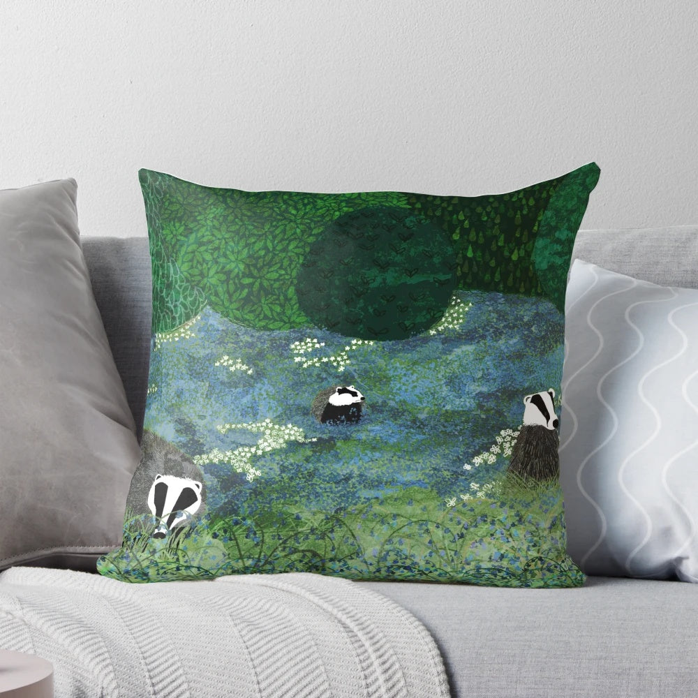 Throw pillow featuring an illustration of badgers among a field of blue flowers in a forested setting
