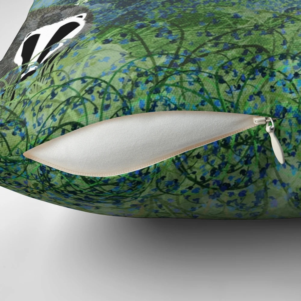 Throw pillow featuring an illustration of badgers among a field of blue flowers in a forested setting
