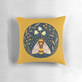 Decorative pillow featuring a golden floral design with buzzing bees