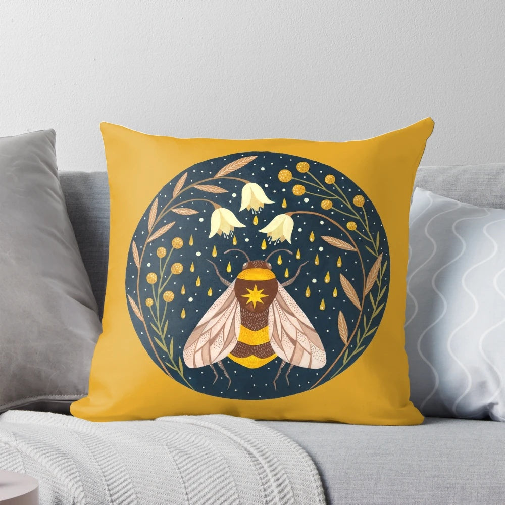 Decorative pillow featuring a golden floral design with buzzing bees