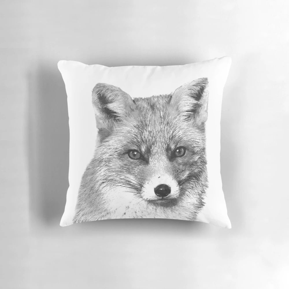 Artistic photograph of a curious black and white fox peeking out from the forest