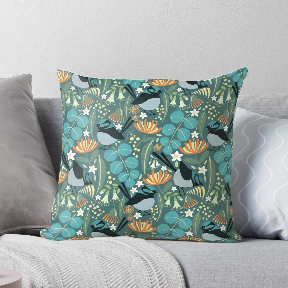A vibrant blue wren bird perched on a blue gum tree branch, featured on a plush decorative pillow.