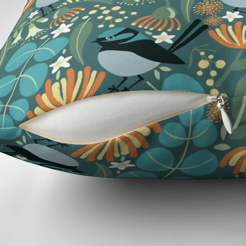 A vibrant blue wren bird perched on a blue gum tree branch, featured on a plush decorative pillow.