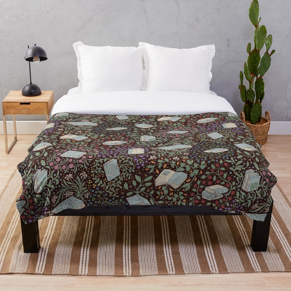 Soft and cozy plush blanket featuring a whimsical design of books and flowers in a fantasy woodland setting