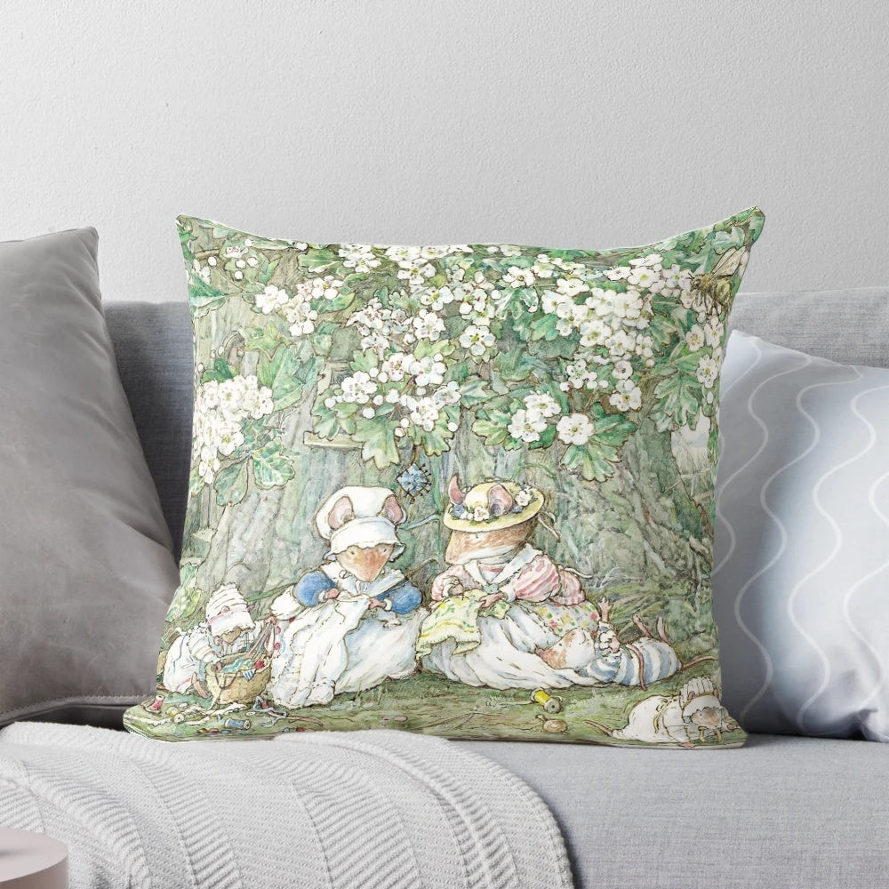 A decorative baby pillow featuring a charming Brambly Hedge-inspired design with hawthorn blossom and baby mice.