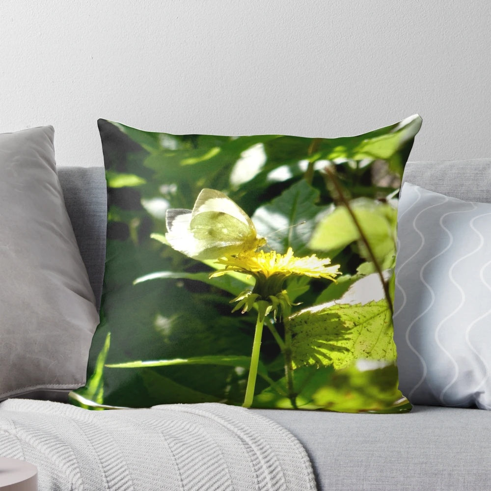 A beautifully detailed pillow featuring a butterfly resting on a dandelion, showcasing the intricate beauty of nature.