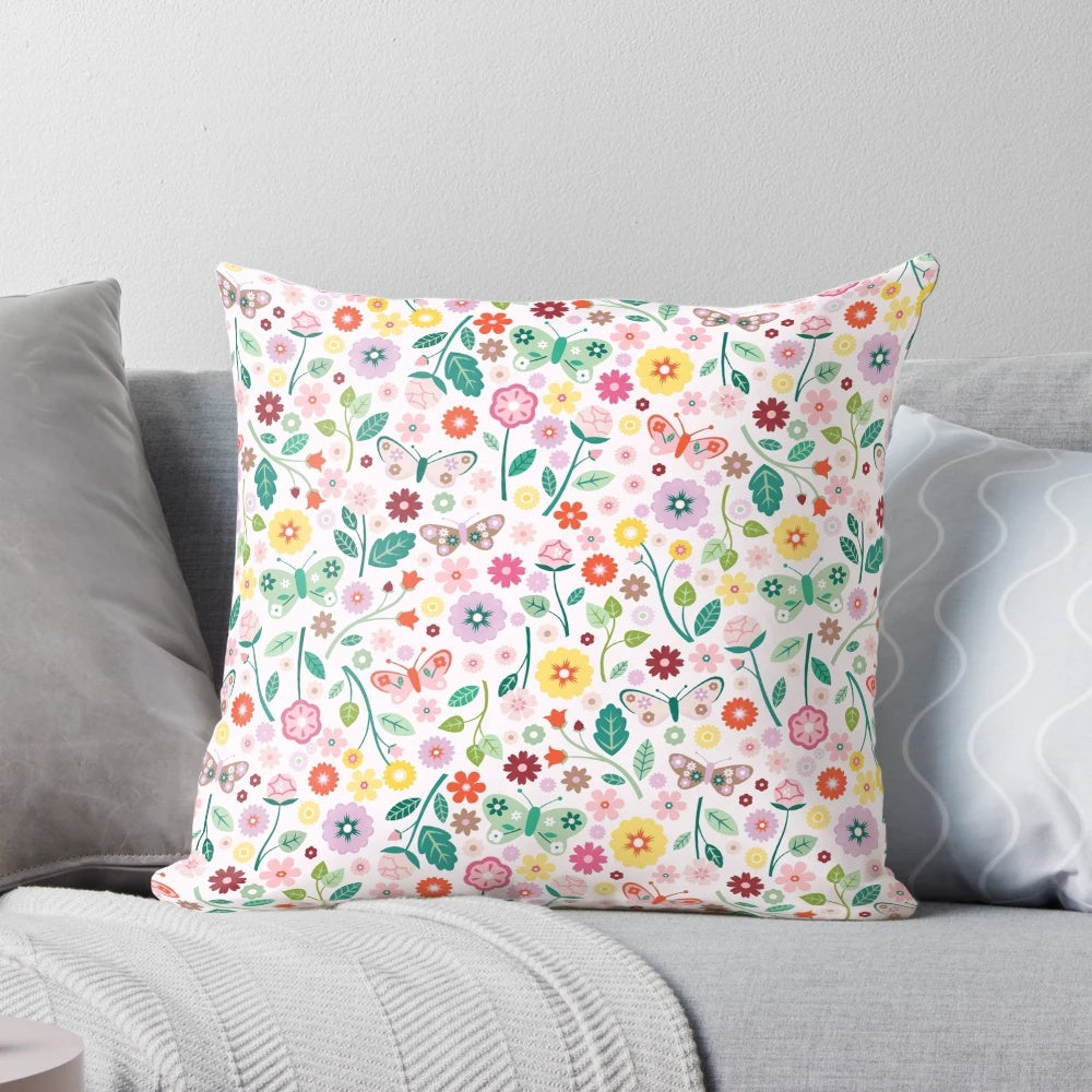 A soft, pastel-colored pillow featuring a whimsical butterfly garden design, perfect for adding a touch of nature to any room.