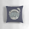 Cozy pillow featuring a whimsical cat in a night town scene with the moon, stars, and houses.