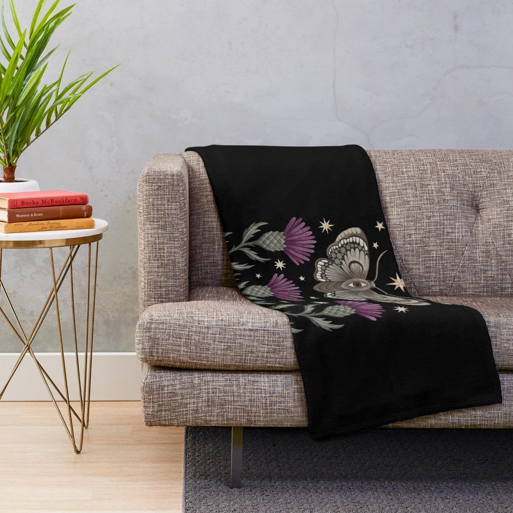 Enchanting plush blanket featuring a celestial moth design with flowers, thistles, and crescent moons