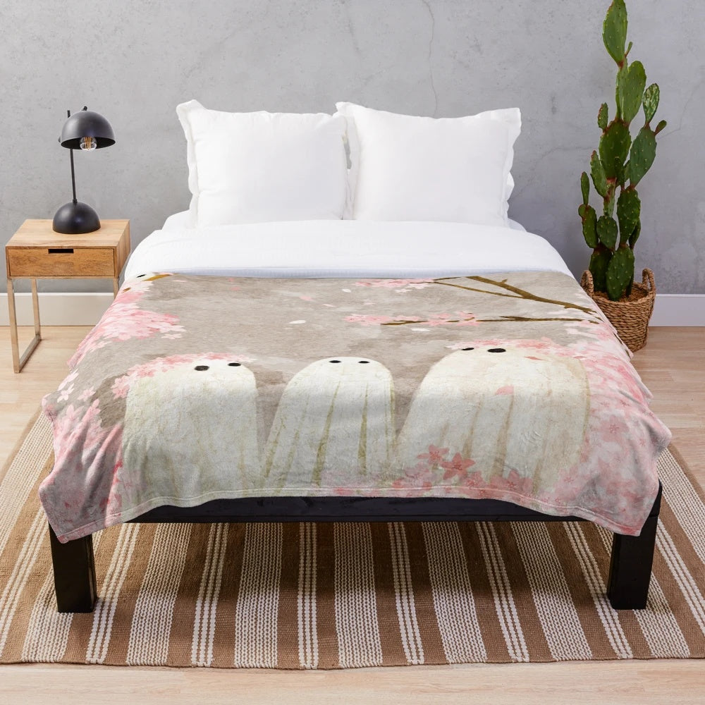 Soft and cozy cherry blossom plush blanket with delicate pink floral design