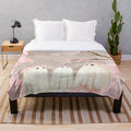 Soft and cozy cherry blossom plush blanket with delicate pink floral design