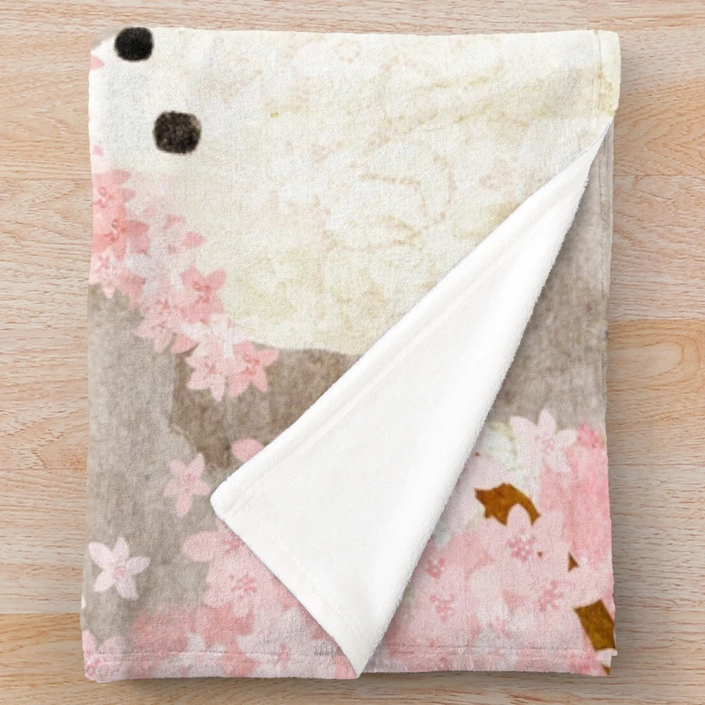 Soft and cozy cherry blossom plush blanket with delicate pink floral design