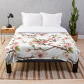 Cherry blossom patterned plush blanket with pink floral design