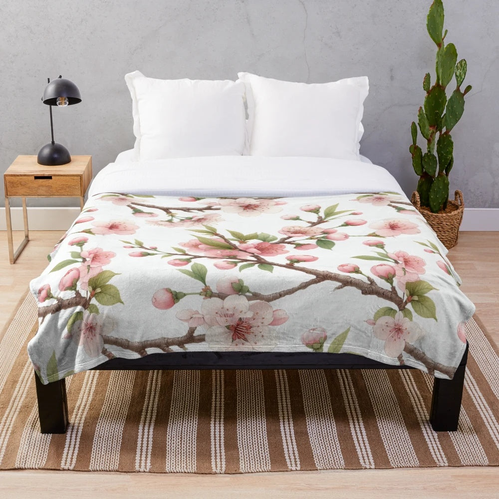 Cherry blossom patterned plush blanket with pink floral design