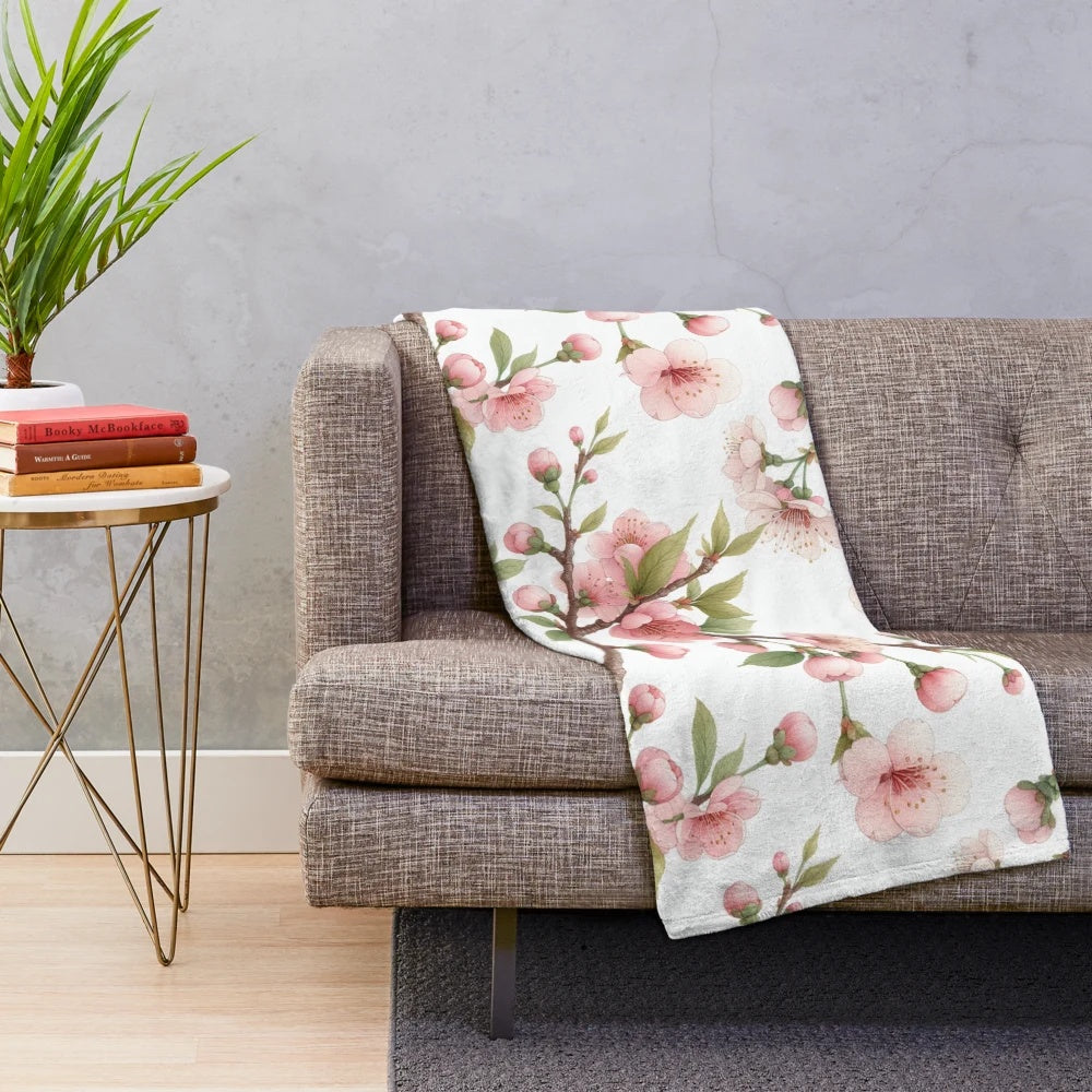 Cherry blossom patterned plush blanket with pink floral design