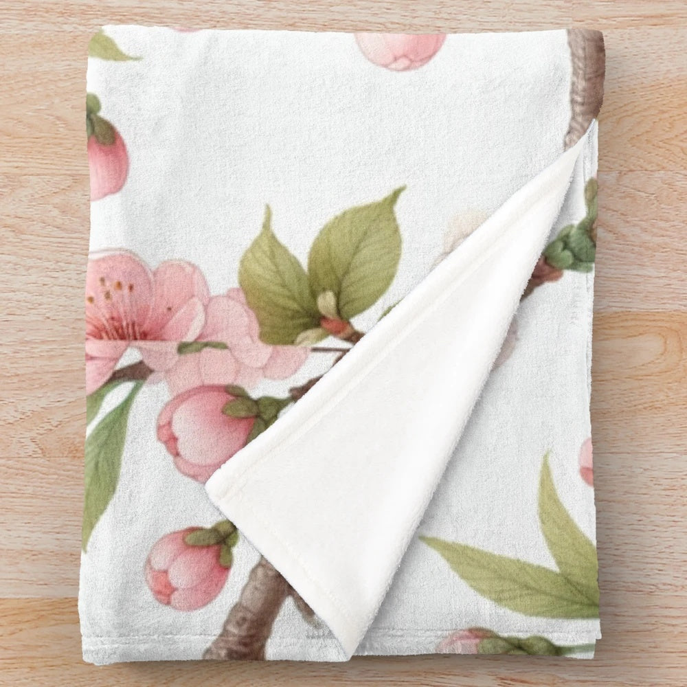 Cherry blossom patterned plush blanket with pink floral design