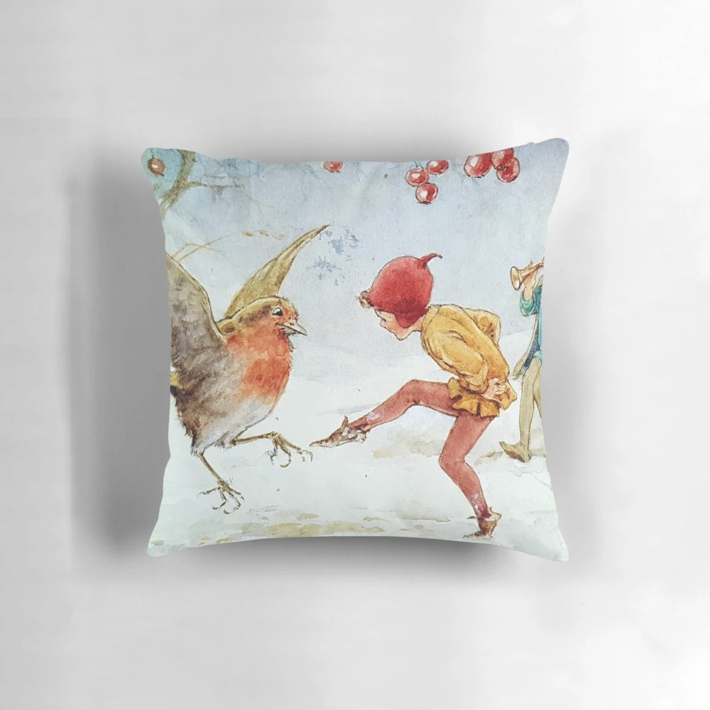 Whimsical pillow featuring illustrated elves and robins dancing in a snowy winter scene by artist Margaret Tarrant