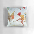 Whimsical pillow featuring illustrated elves and robins dancing in a snowy winter scene by artist Margaret Tarrant