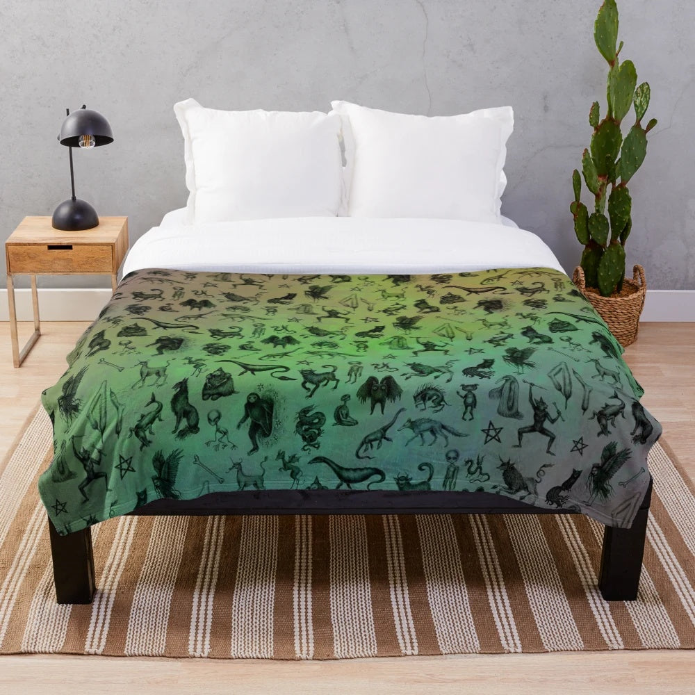 Colorful plush blanket featuring a variety of mythical cryptids and creatures
