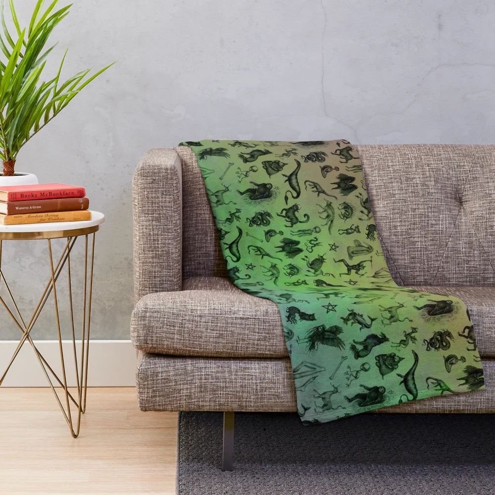 Colorful plush blanket featuring a variety of mythical cryptids and creatures