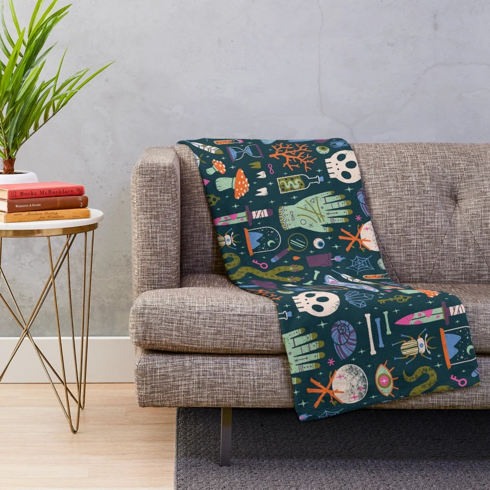 Curiosities plush blanket featuring a cabinet of wonders design