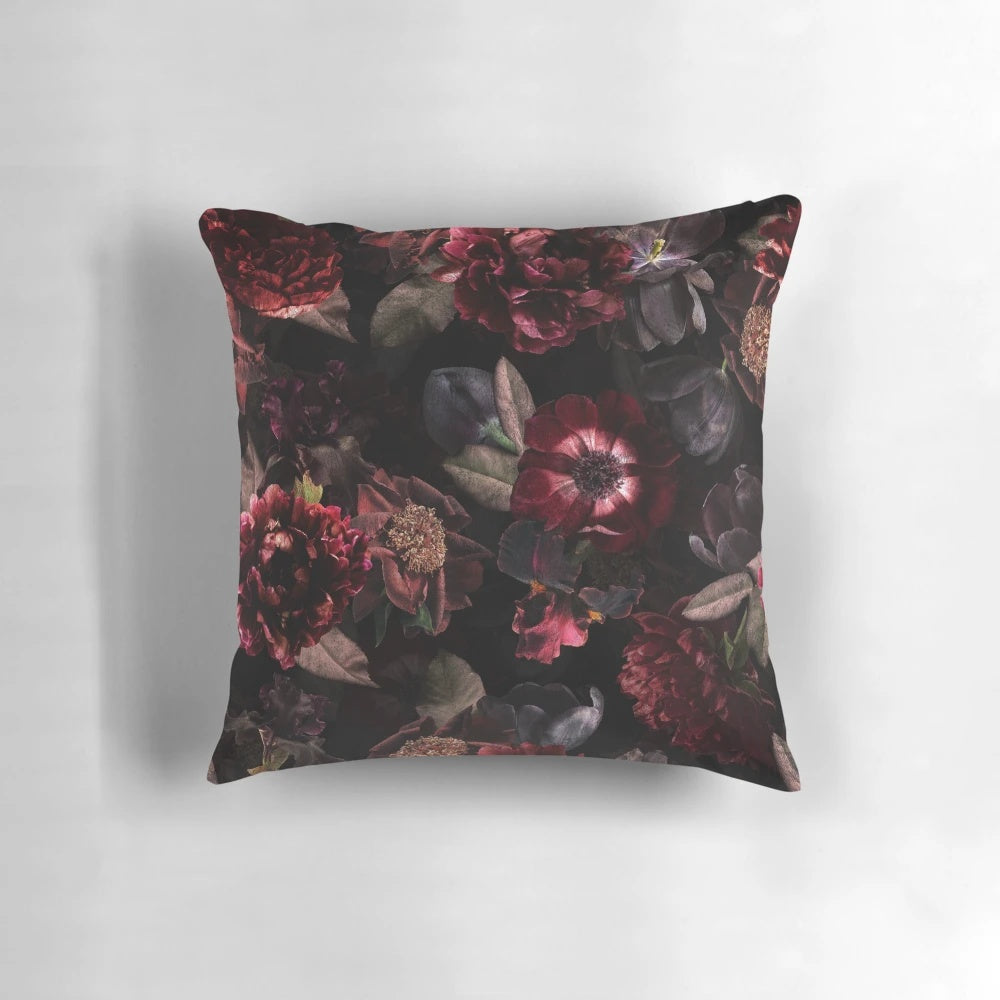 Dark midnight roses and botanical elements on a cozy, pillow for a mystical garden ambiance.