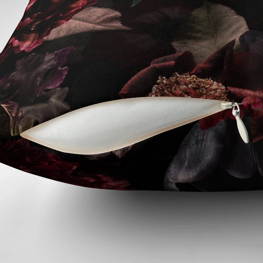 Dark midnight roses and botanical elements on a cozy, pillow for a mystical garden ambiance.