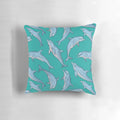 Three decorative pillows featuring a detailed dolphin design in shades of blue and grey, created with ink and pen artwork.