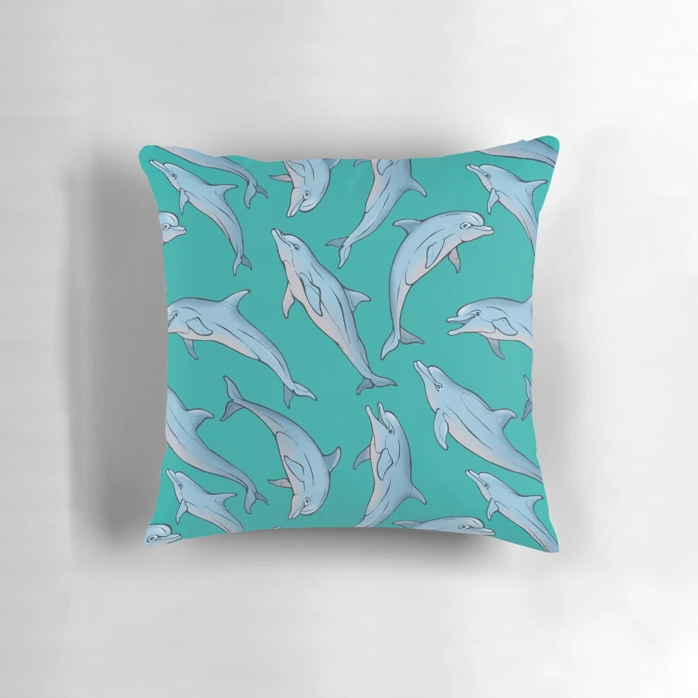 Three decorative pillows featuring a detailed dolphin design in shades of blue and grey, created with ink and pen artwork.