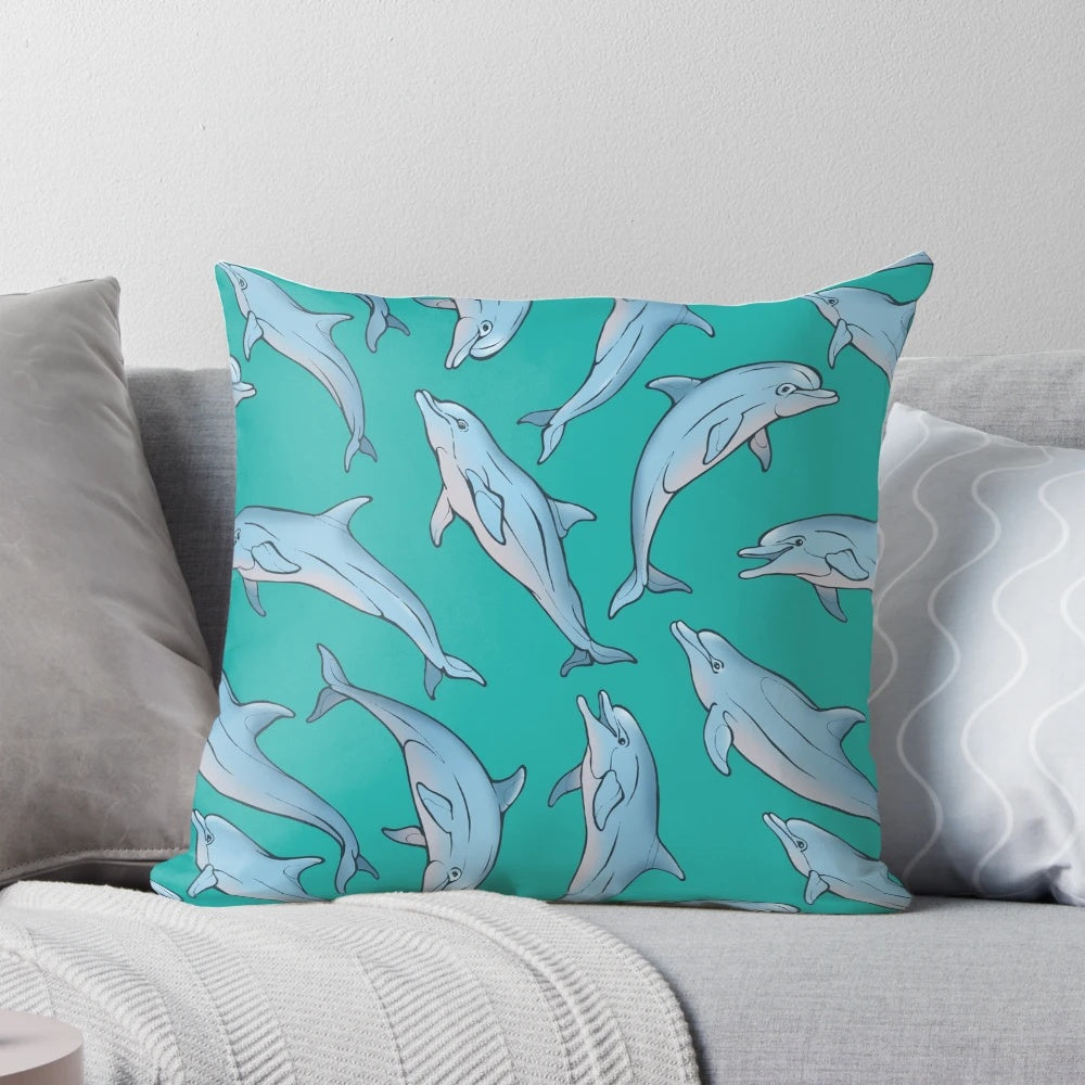 Three decorative pillows featuring a detailed dolphin design in shades of blue and grey, created with ink and pen artwork.