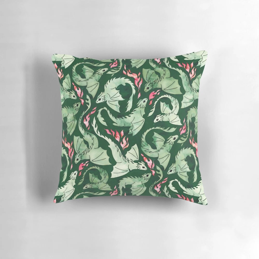 A beautifully designed dragon fire dark green pillow featuring a watercolor-inspired design of a fire-breathing dragon in shades of green, blue, and scarlet.