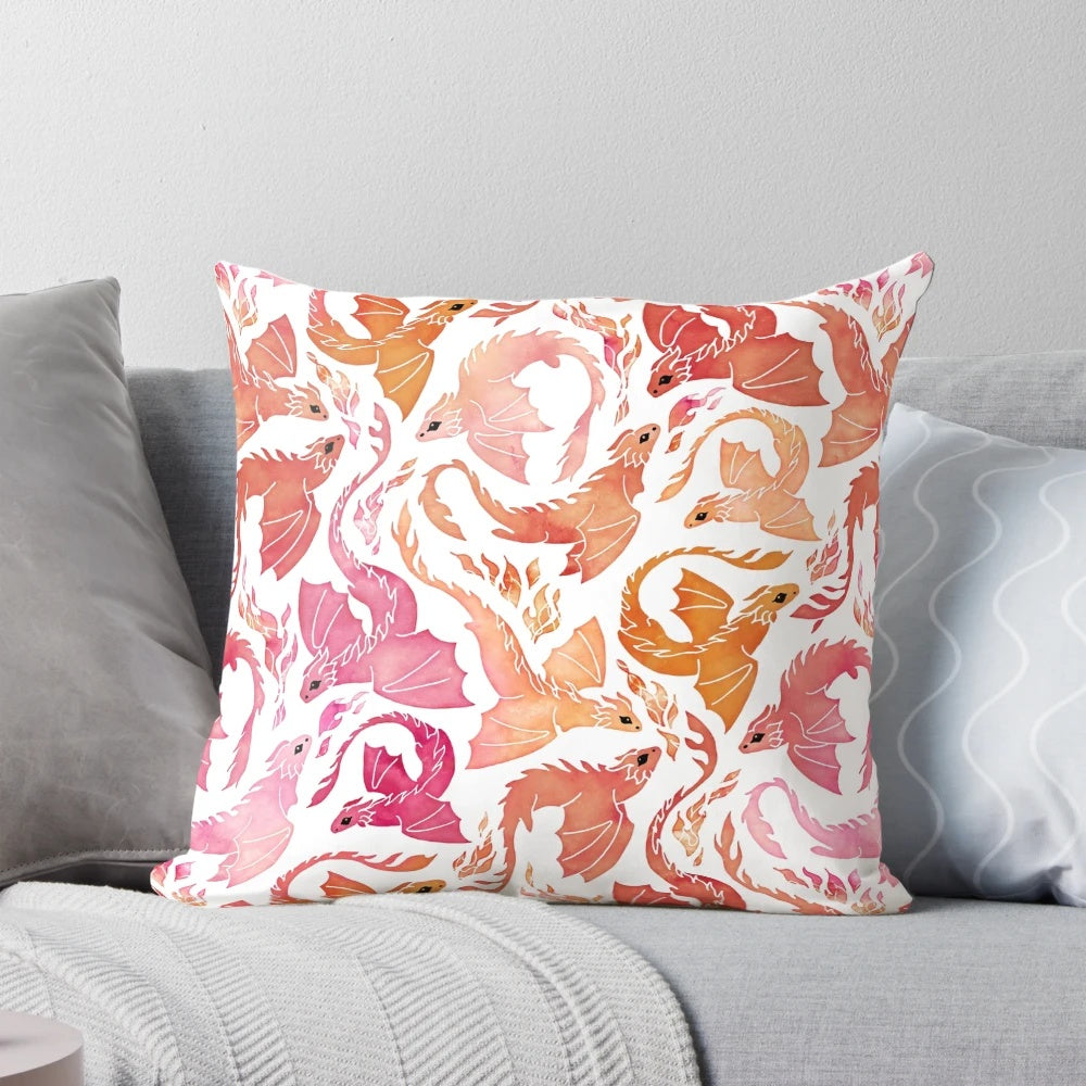Whimsical watercolor-style dragon pillow with fiery pink and orange colors, perfect for adding a touch of magic to your home decor.