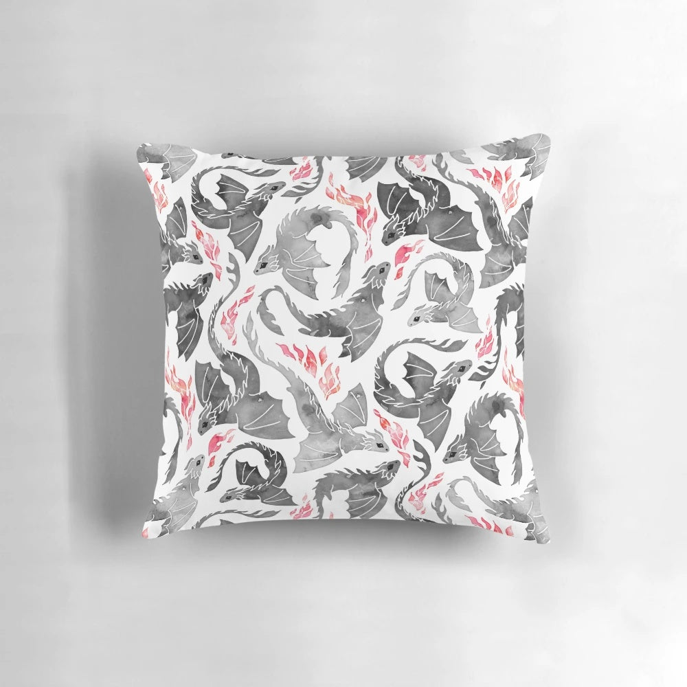 Artistic illustration of a dragon breathing fire in shades of grey and black on a Pillow product.