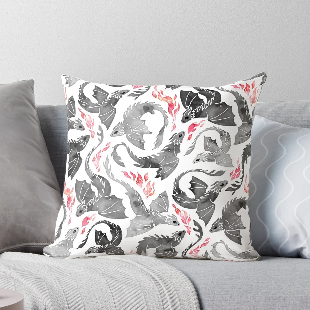 Artistic illustration of a dragon breathing fire in shades of grey and black on a Pillow product.