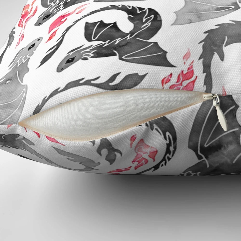 Artistic illustration of a dragon breathing fire in shades of grey and black on a Pillow product.