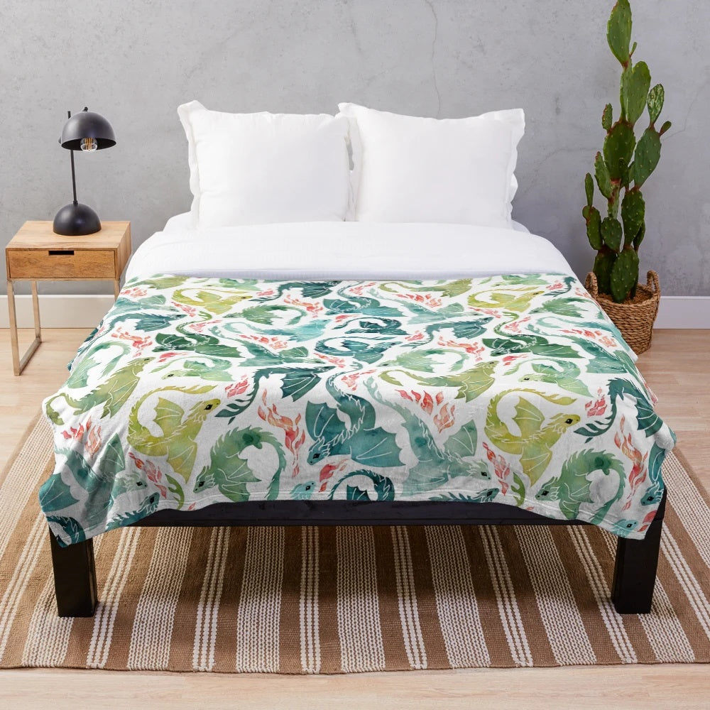Turquoise and green plush blanket with a dragon fire design