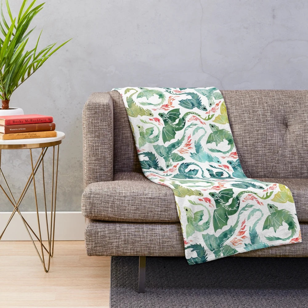 Turquoise and green plush blanket with a dragon fire design