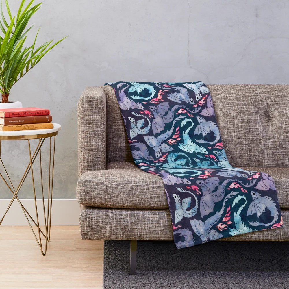 Plush blanket featuring a whimsical dragon design in shades of turquoise and purple