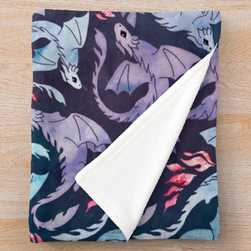 Plush blanket featuring a whimsical dragon design in shades of turquoise and purple