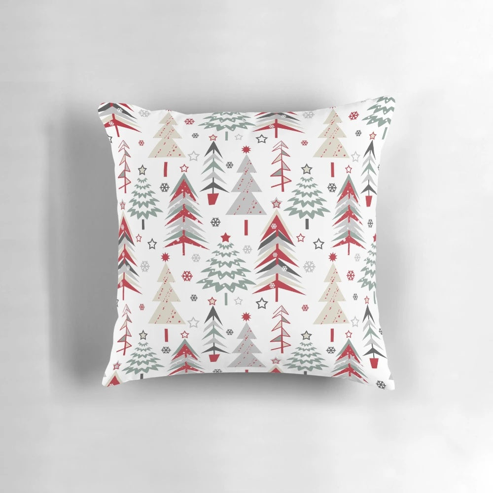 A cozy pillow featuring a whimsical forest scene with spruce trees, a Christmas tree, and a festive red and white palette, perfect for the holiday season.