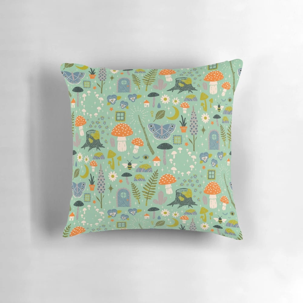 Whimsical fairy garden-inspired throw pillow with mint, pastel, and floral motifs