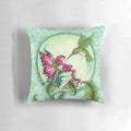 Whimsical fairy pillow featuring a hummingbird design by artist Amy Brown in shades of pink and green.