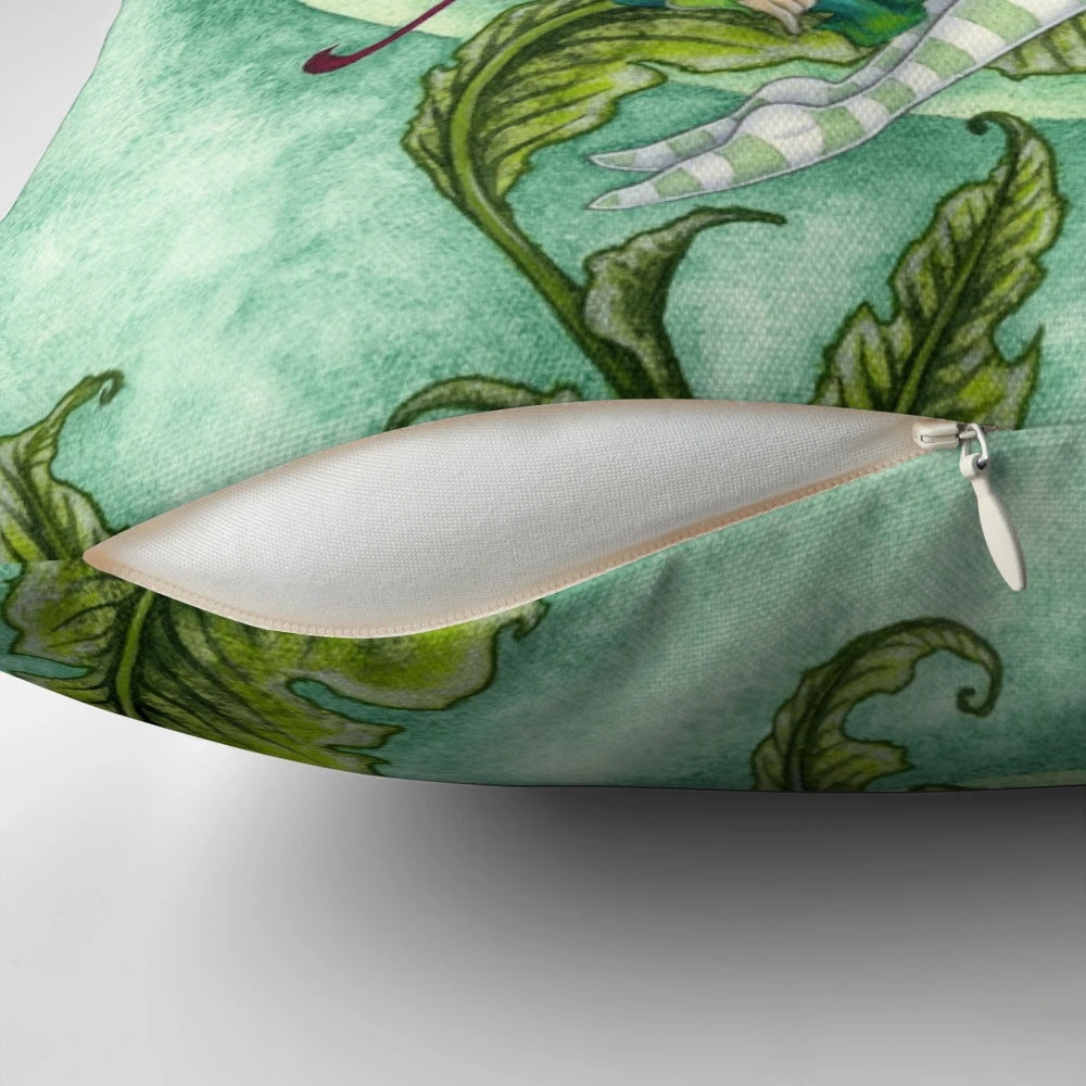Whimsical fairy pillow featuring a hummingbird design by artist Amy Brown in shades of pink and green.